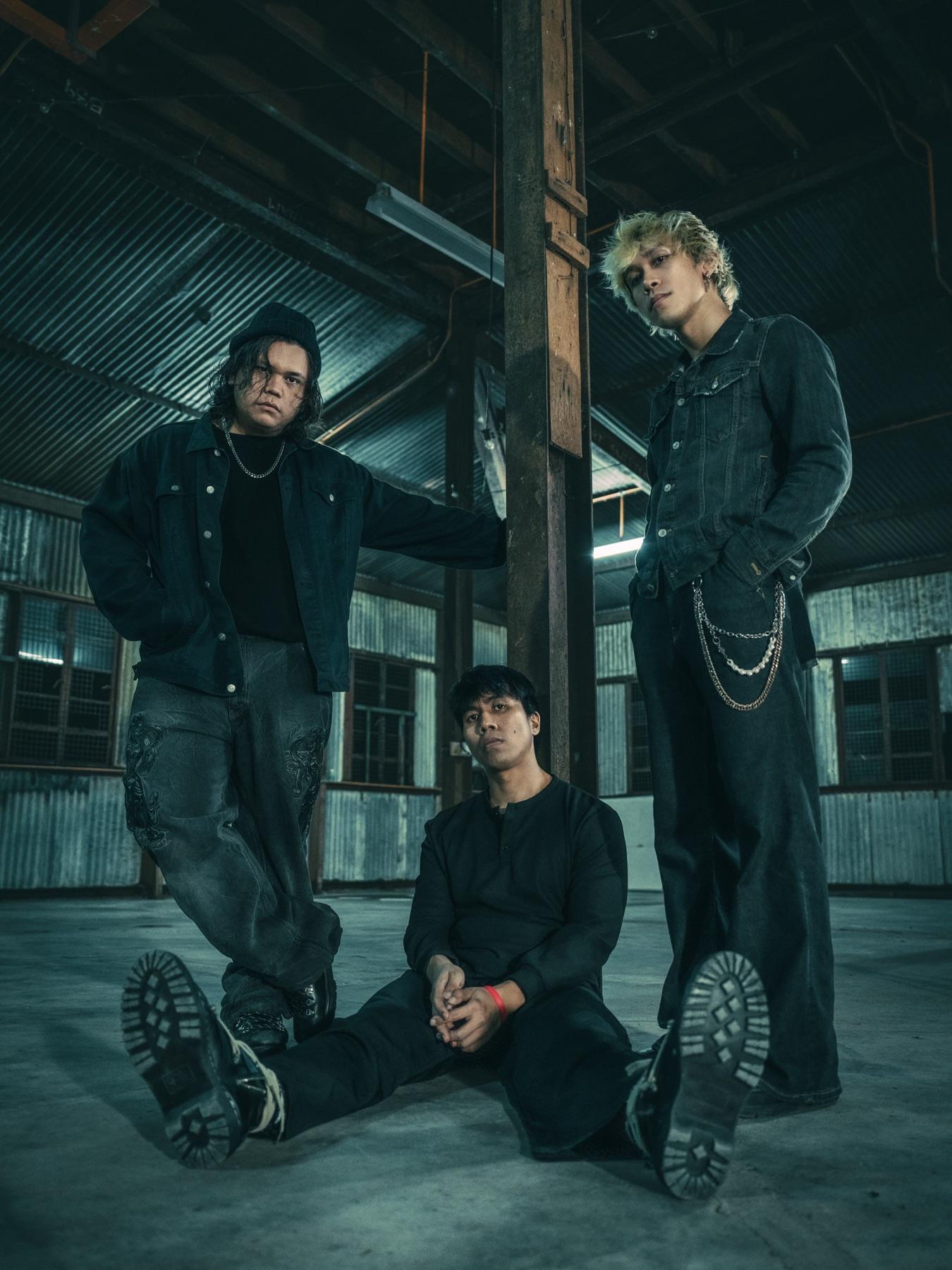 The three members of empty page. together in an industrial interior